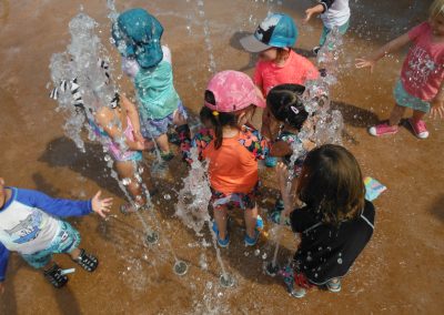 A Bunch of Children Playing With Water From Fountains