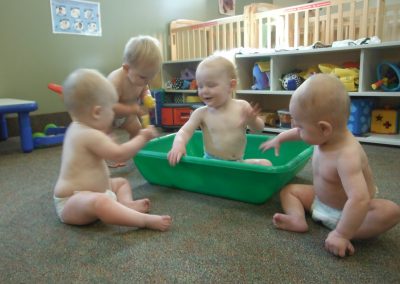 A Group of Babies Playing in a Green Tub